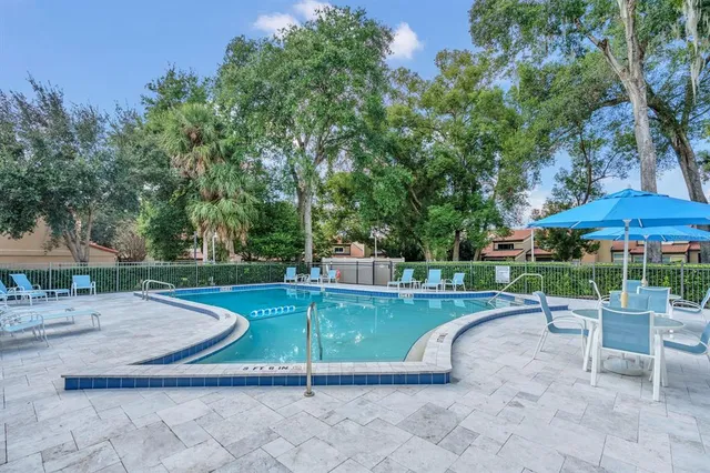 a view of a swimming pool with a patio