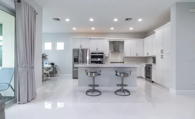 a kitchen with stainless steel appliances kitchen island granite countertop a sink and cabinets