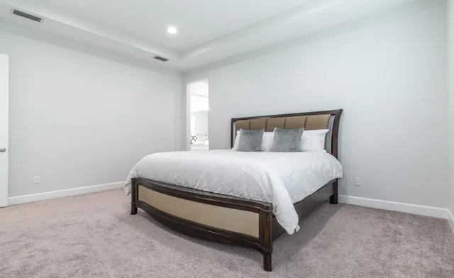 a bedroom with a bed and a night stand