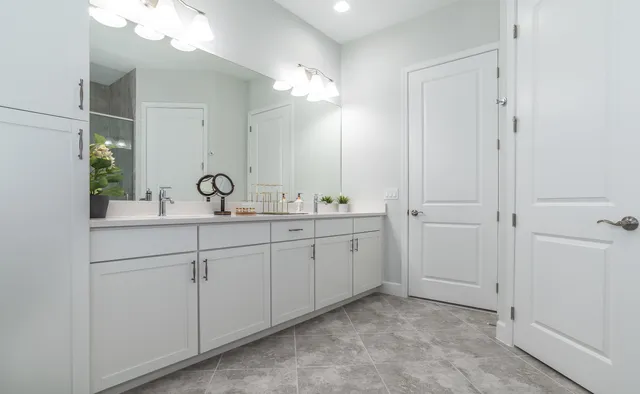 a bathroom with a double vanity sink mirror and double