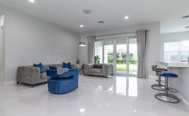 a kitchen with refrigerator and chairs