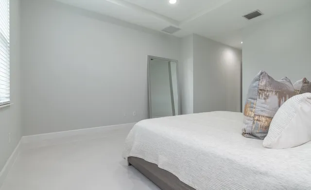 a living room with furniture a clock and a large mirror