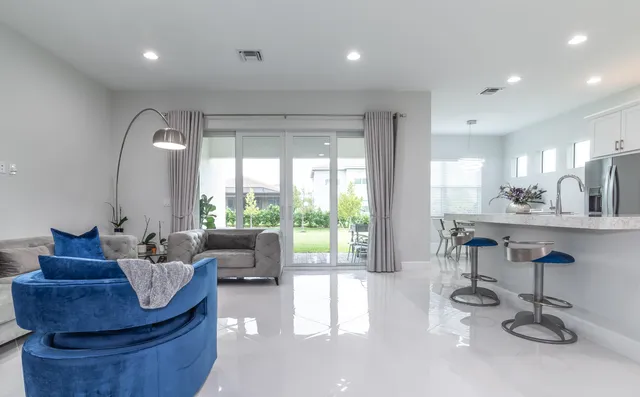 a kitchen with stainless steel appliances granite countertop a sink a stove a refrigerator and cabinets