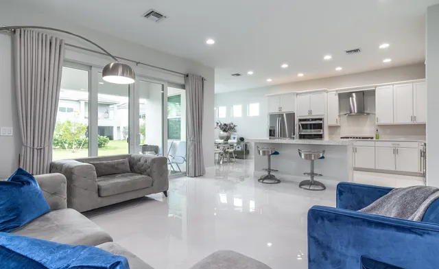 a kitchen with stainless steel appliances granite countertop a sink and a refrigerator