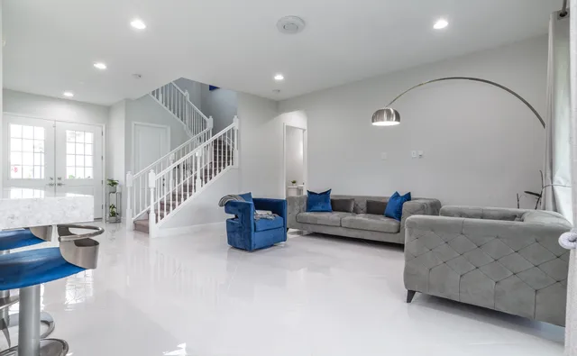 a kitchen with stainless steel appliances granite countertop a sink a stove and a refrigerator