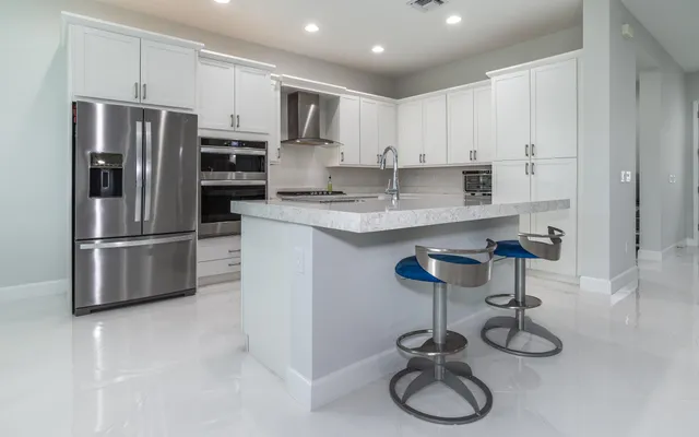 a kitchen with stainless steel appliances a refrigerator sink and stove