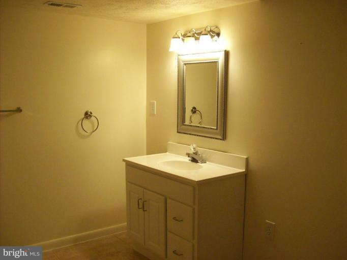 114 Hoofprint Drive Bunker Hill, WV 25413 - Photo 2 of 13 a bathroom with a sink and mirror