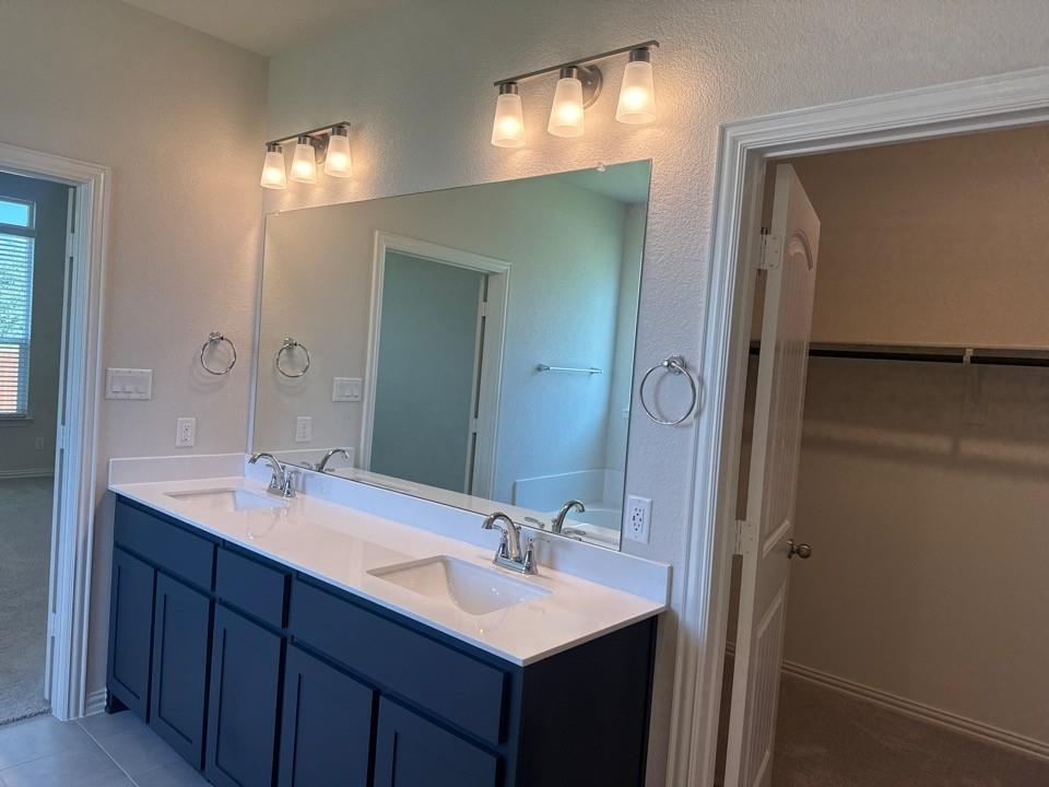 1233 Frio Drive Springtown, TX 76082 - Photo 8 of 13 Double vanity with white countertops, undermount sinks, and chrome faucets
