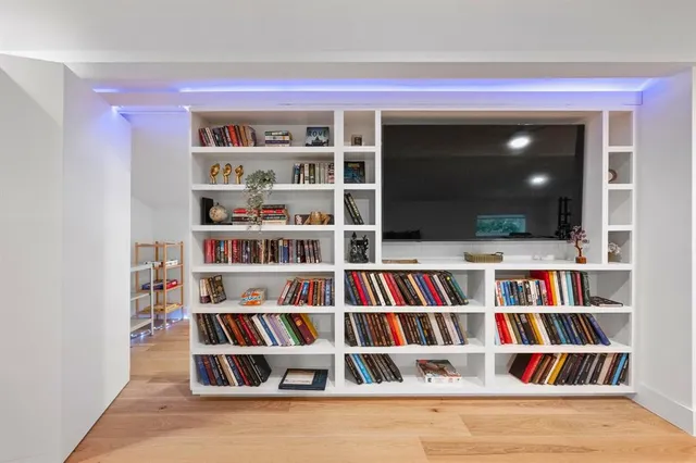 a view of room with cabinets and book shelf