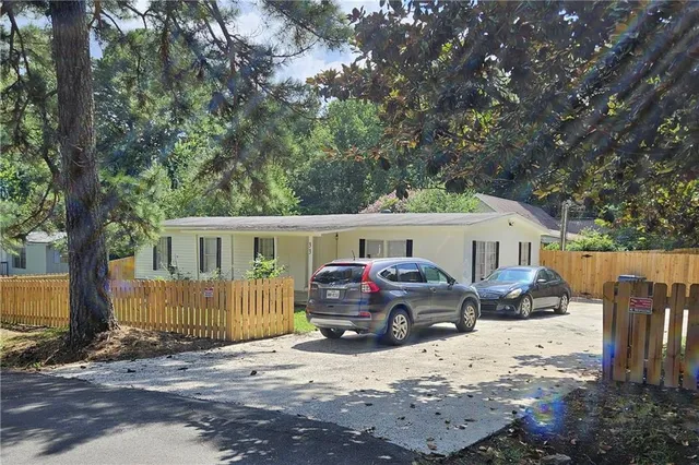a front view of a house with a yard covered in snow