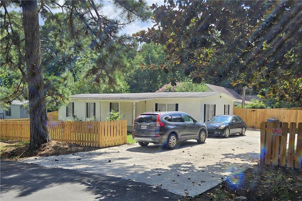 33 Cedar Lane Northwest Rome, GA 30165 - Photo 1 of 22 a front view of a house with a yard covered in snow