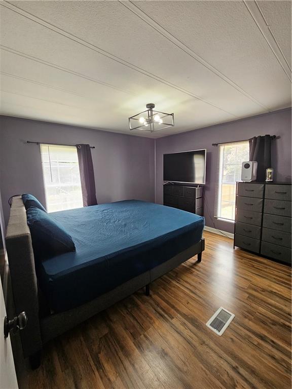 33 Cedar Lane Northwest Rome, GA 30165 - Photo 14 of 22 a bedroom with a bed and wooden floor