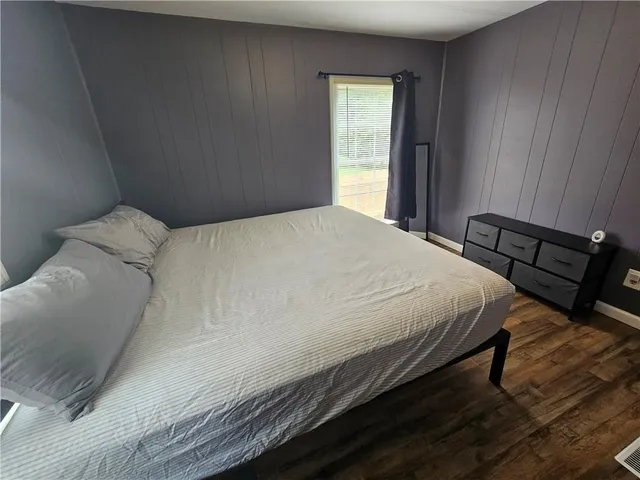 a bedroom with a bed and window