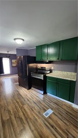 a kitchen with a refrigerator and a sink