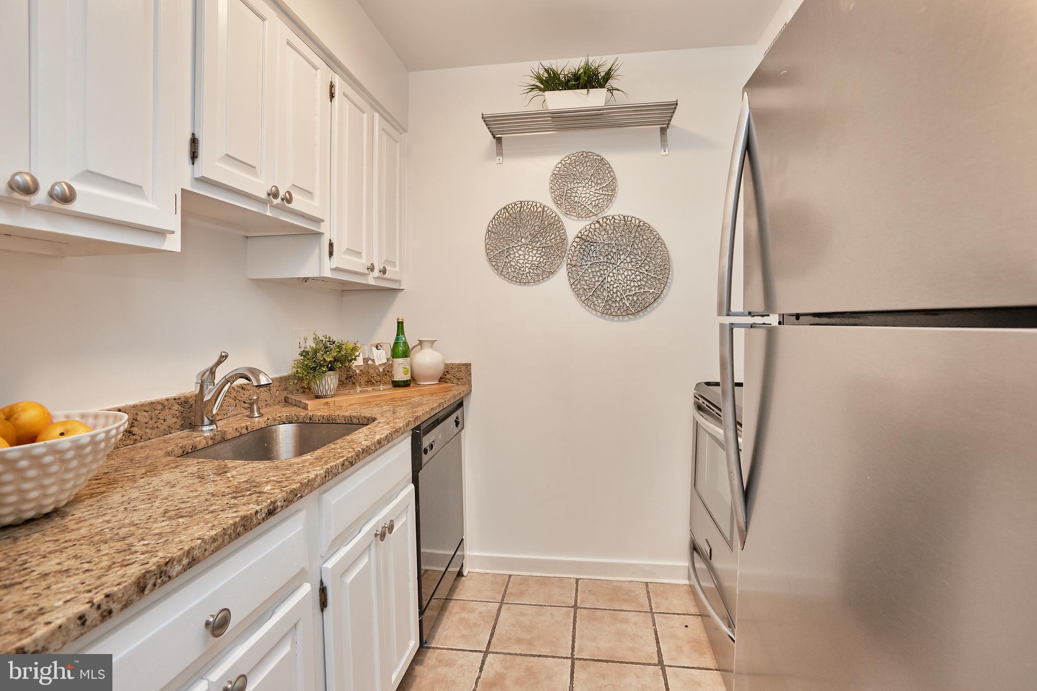 2248 Washington Avenue, Unit W102 Silver Spring, MD 20910 - Photo 3 of 28 Granite counters and stainless steel appliances.