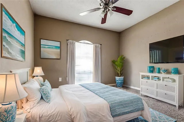 a bedroom with a bed and a flat screen tv