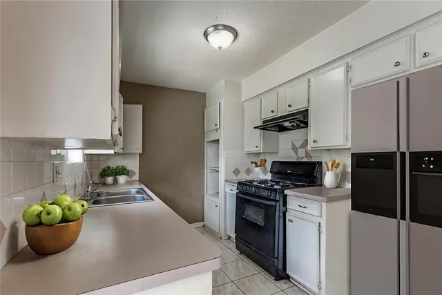 a kitchen with a sink and a stove top oven