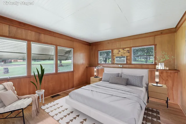 a bedroom with a large bed and a window