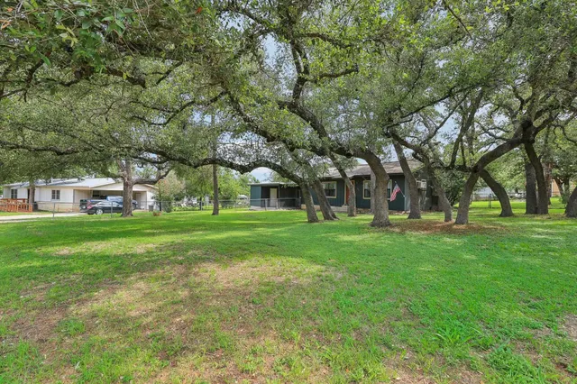 a view of house with outdoor space and garden