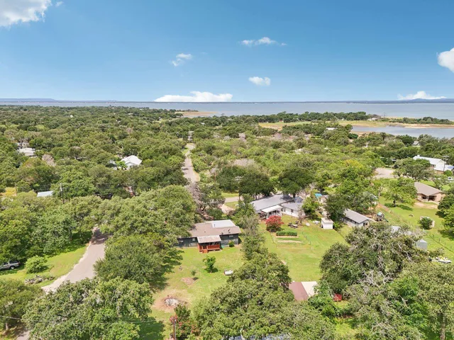an aerial view of a house with a yard and garden
