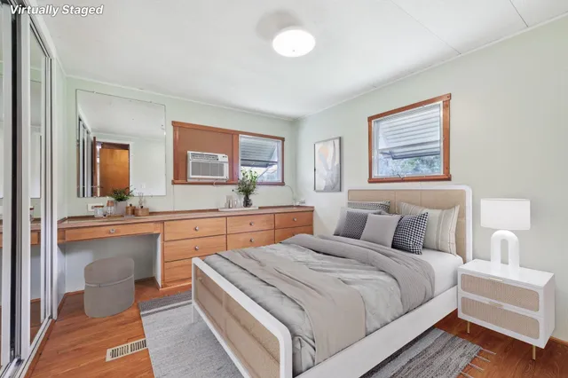 a bedroom with bed and a large mirror