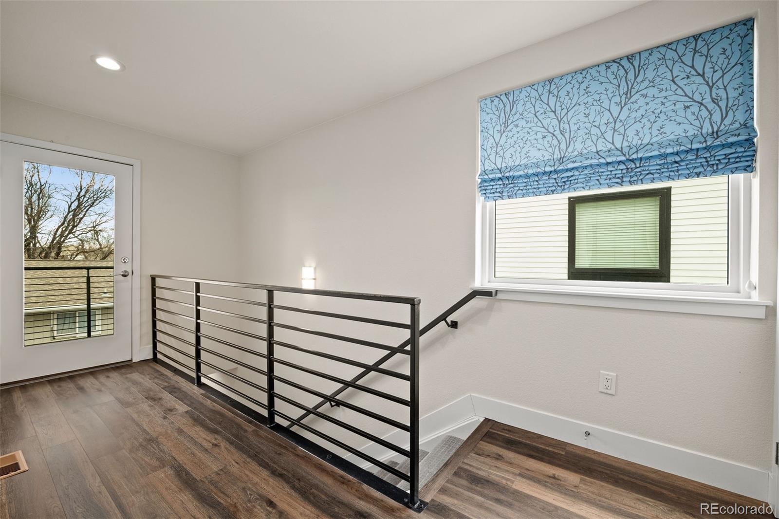 1204 South Reed Street Lakewood, CO 80232 - Photo 10 of 45 a view of a livingroom with wooden floor and window