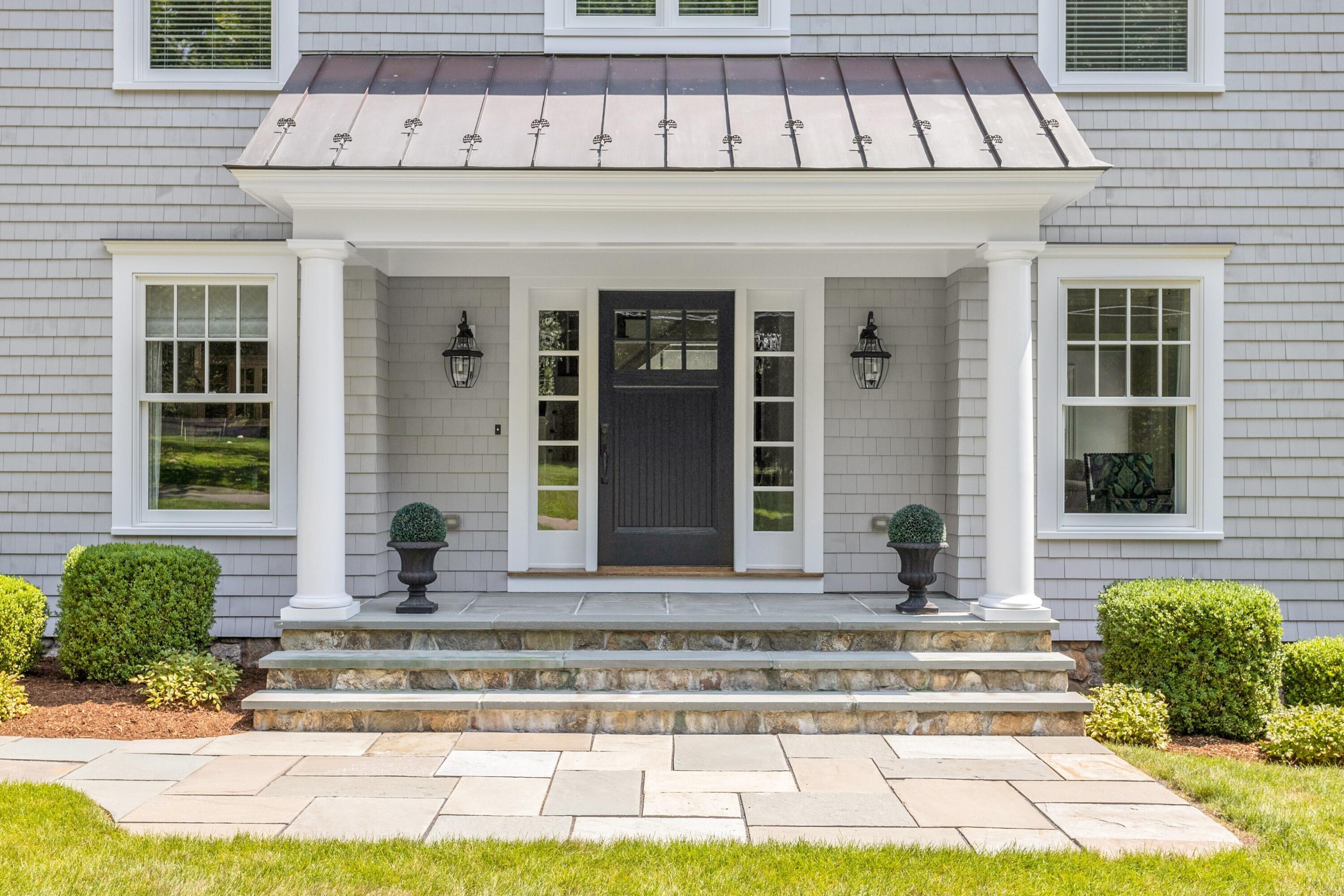 46 Stanton Road Darien, CT 06820 - Photo 3 of 48 a front view of a house with lots of windows and plants