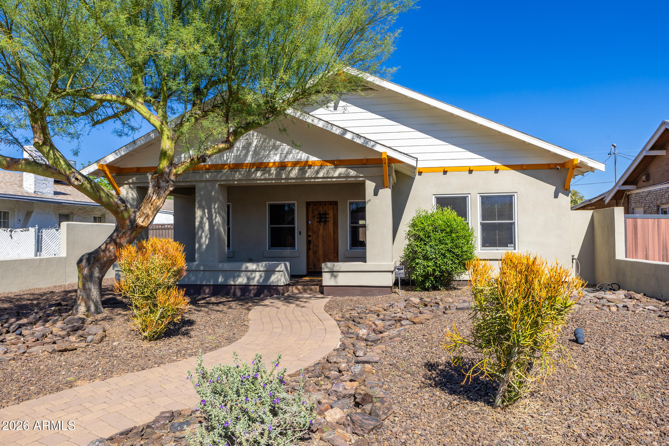 a front view of a house with outdoor seating