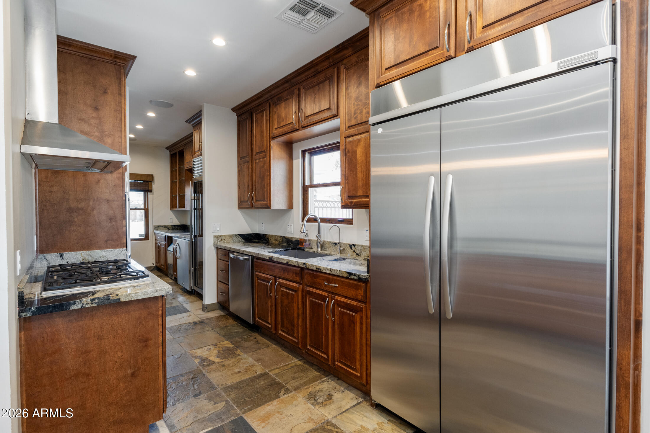 2517 North 8th Street Phoenix, AZ 85006 - Photo 11 of 48 a kitchen with stainless steel appliances granite countertop a refrigerator a stove and a refrigerator