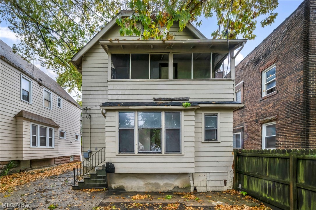 Back of house with a sunroom