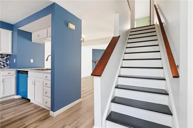 a view of entryway and hall with wooden floor