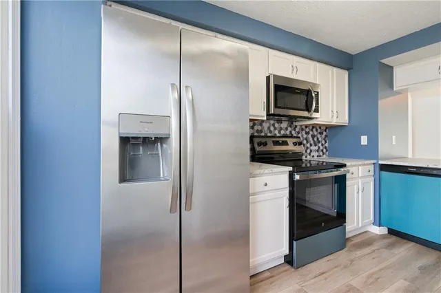 a kitchen with a refrigerator stove and microwave