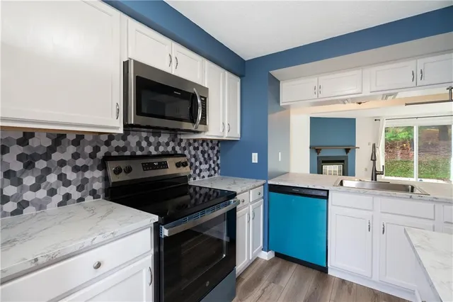 a kitchen with a sink stove and microwave