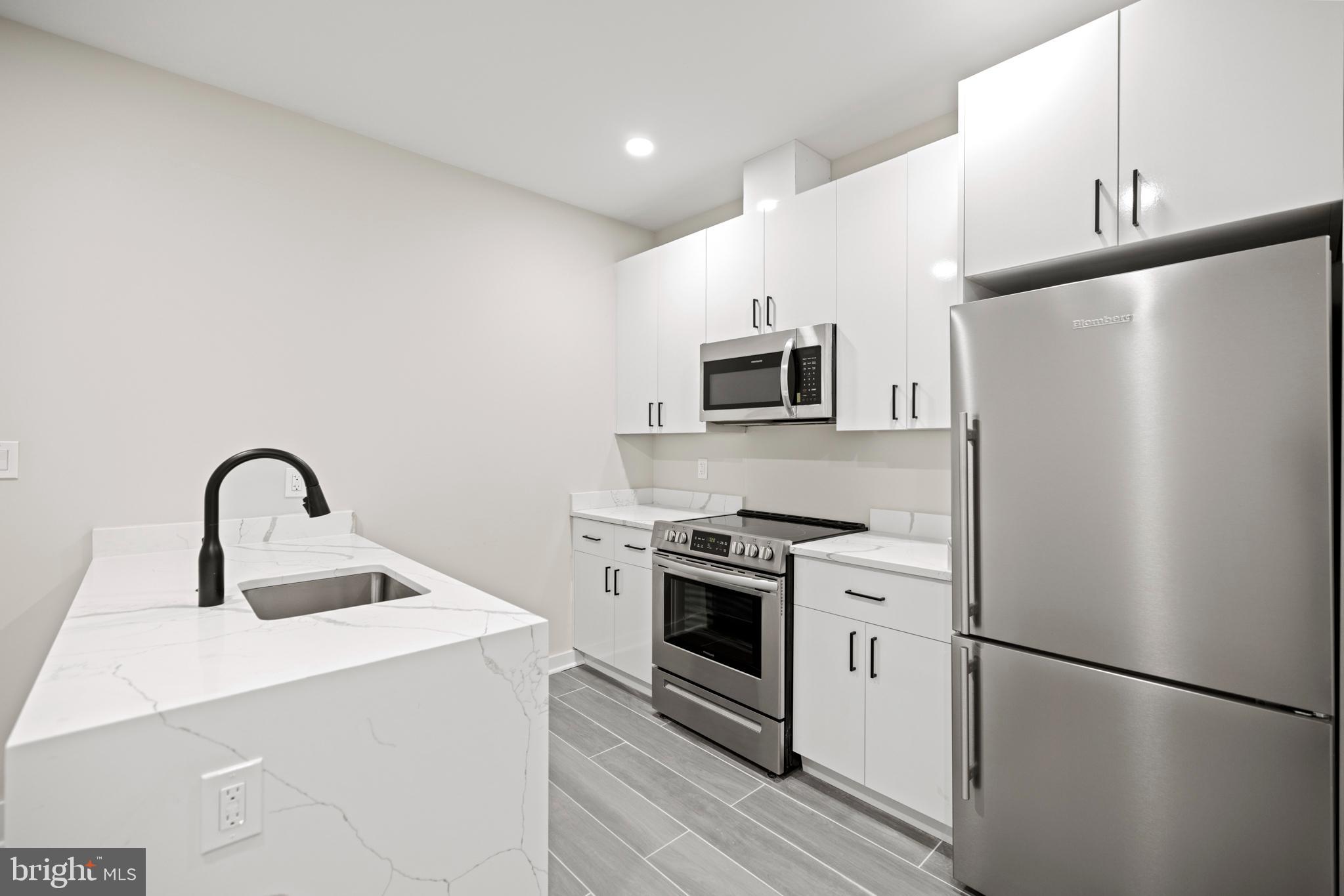 824 18th Street Northeast, Unit 2 Washington, DC 20002 - Photo 7 of 15 a kitchen with a refrigerator stove and sink