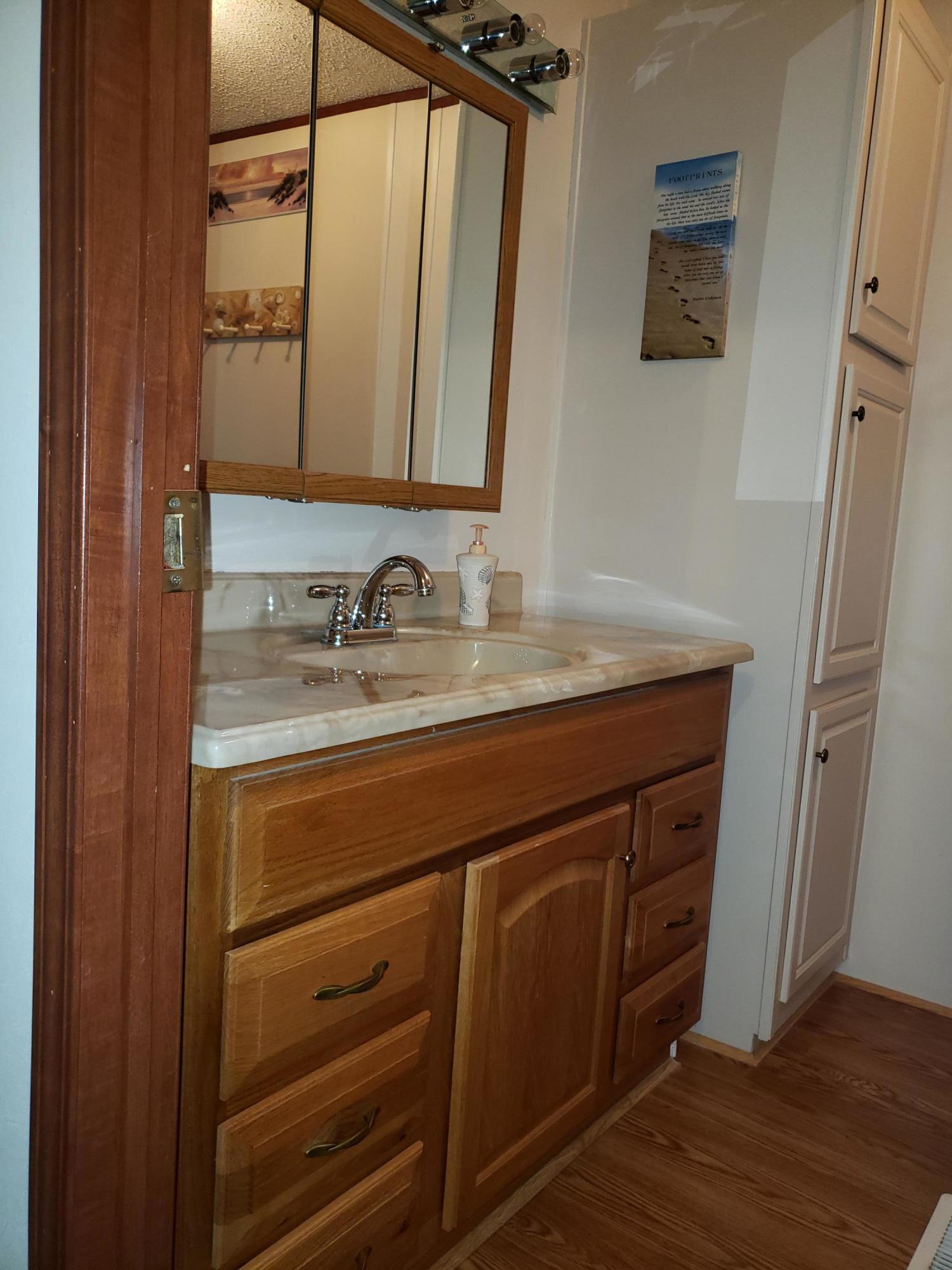 2459 Stout Road Northwest Ash, NC 28420 - Photo 11 of 19 Updated raised vanity with cultured marble sink & vanity top.