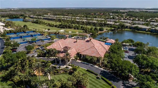 an aerial view of residential houses with outdoor space and lake view