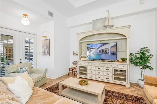 a living room with furniture a potted plant and a fireplace