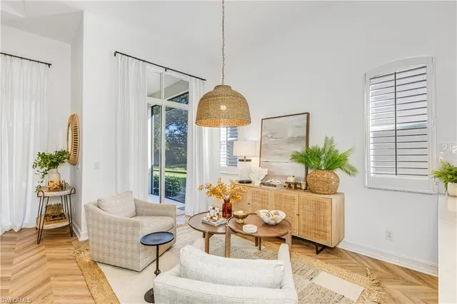 a living room with furniture and a potted plant