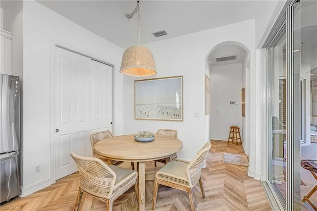 a view of a dining room with a table and chairs