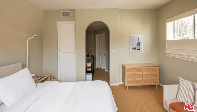 a bedroom with a bed and a cabinets