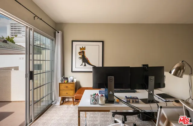 a living room with furniture a rug and a window