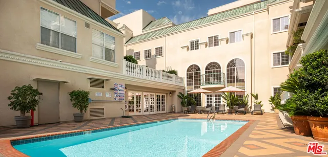 a front view of a house with swimming pool having outdoor seating