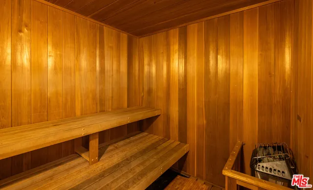 a view of a room with a chair and potted plant on the table