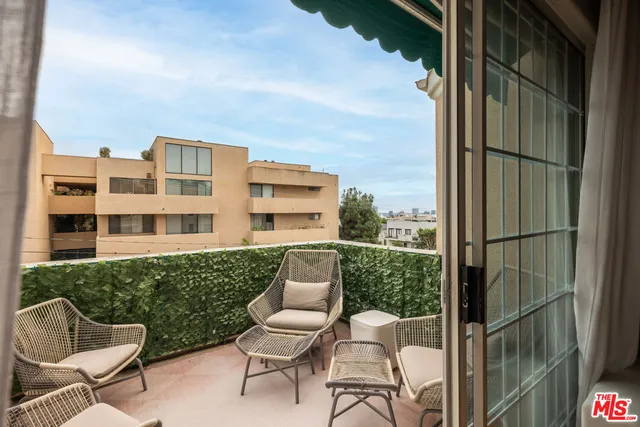 a balcony with table and chairs