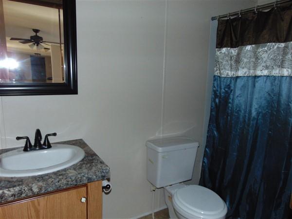 1051 Hinote Road DeFuniak Springs, FL 32433 - Photo 13 of 39 a bathroom with a sink and a toilet