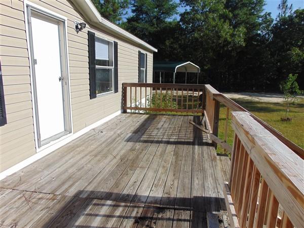 1051 Hinote Road DeFuniak Springs, FL 32433 - Photo 19 of 39 a view of a deck with wooden floor and barbeque oven