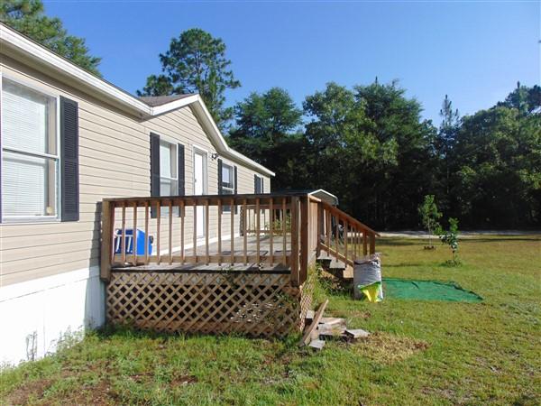 1051 Hinote Road DeFuniak Springs, FL 32433 - Photo 25 of 39 a view of a house with a yard