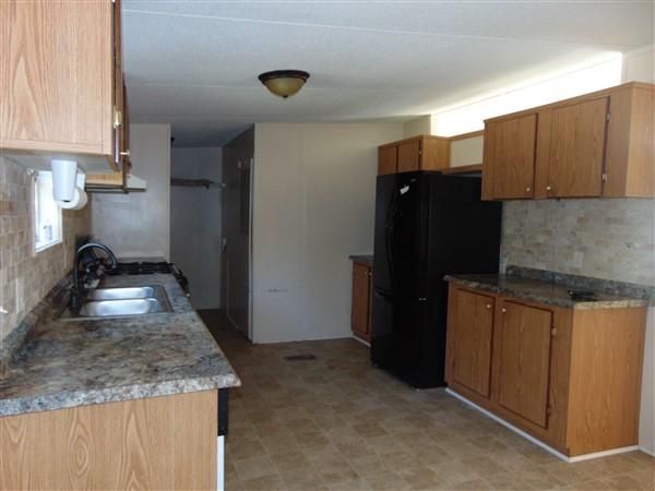 1051 Hinote Road DeFuniak Springs, FL 32433 - Photo 29 of 39 a kitchen with a refrigerator and a sink