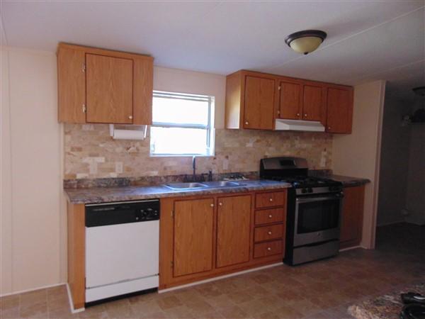 1051 Hinote Road DeFuniak Springs, FL 32433 - Photo 30 of 39 a kitchen with stainless steel appliances granite countertop a stove and a sink
