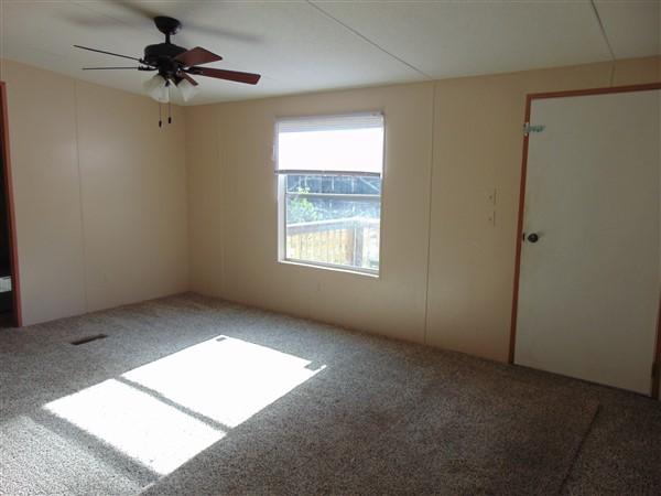 1051 Hinote Road DeFuniak Springs, FL 32433 - Photo 31 of 39 an empty room with a window and a ceiling fan